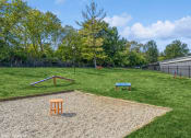 Thumbnail 28 of 35 - a fenced in backyard with a grassy field and a playground with a bench at Runaway Bay Apartments, Columbus, 43204