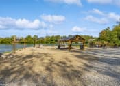 Thumbnail 18 of 35 - a picnic pavilion with a lake in the background at Runaway Bay Apartments, Columbus, Ohio
