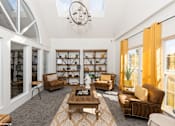 Thumbnail 43 of 46 - A living room with a brown sofa, a wooden coffee table, and a chandelier at Island Club Apartments, Ohio, 43235