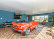Thumbnail 33 of 35 - a pool table in a living room with a orange truck in the middle at Runaway Bay Apartments, Columbus, OH