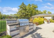 Thumbnail 24 of 35 - the backyard has a grill and a patio with a house at Runaway Bay Apartments, Columbus, OH, 43204