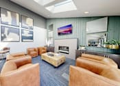 Thumbnail 5 of 20 - A modern living room with a skylight, a flat screen TV, and a coffee table.