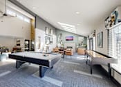 Thumbnail 4 of 20 - A spacious room with a pool table and comfortable seating.