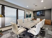 Thumbnail 6 of 20 - A conference room with a long table and chairs.