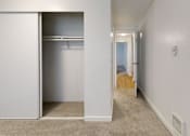 Thumbnail 17 of 20 - A white closet with a white door is open to a hallway.
