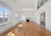 Thumbnail 23 of 25 - Penthouse living room with fireplace and wooden floor at 275 on the Park Apartments, St. Louis