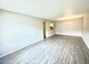 Thumbnail 10 of 12 - an empty living room with wood floors and white walls at Cambridge Village Apartments, Houston, TX ? 
