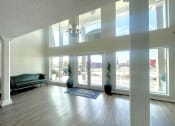 Thumbnail 9 of 12 - an empty living room with a couch and a chandelier at Cambridge Village Apartments, Houston, 77045 ? 