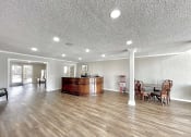 Thumbnail 6 of 12 - a large living room with a bar in the center at Cambridge Village Apartments, Houston, TX 77045 ? 