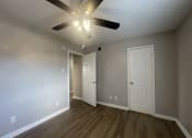 Thumbnail 16 of 17 - the living room of an empty house with a ceiling fan at Whispering Oaks, Conroe, TX 77301 ? 