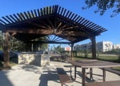 Thumbnail 10 of 17 - a picnic area with a picnic table and a pavilion at Whispering Oaks, Conroe ? 