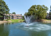 Thumbnail 8 of 9 - a fountain in the middle of a lake with an apartment building in the background at The Grove Germantown Apartments, Tennessee ?