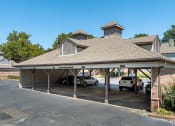 Thumbnail 5 of 9 - a car garage with cars parked in it at The Grove Germantown Apartments, Tennessee, 38138