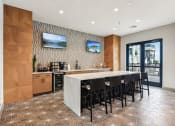 Thumbnail 6 of 35 - a kitchen with a large island and a bar with chairs at The Virginia, Seguin, TX