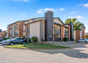 Thumbnail 4 of 42 - A modern building with a brick facade and a large glass window at Water Ridge Apartments , Irving, TX, 75061