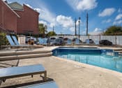 Thumbnail 39 of 42 - Pool Side Relaxing Area With Sundeck at Wildwood Apartments, CLEAR Property Management, Austin, TX, 78752