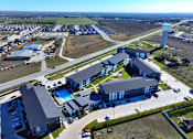 Thumbnail 33 of 35 - A large building complex with a swimming pool in the middle.