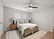 Thumbnail 15 of 30 - A bedroom with a bed, two lamps, and a ceiling fan.
