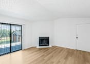 Thumbnail 25 of 42 - A room with a fireplace and a sliding glass door at Water Ridge Apartments , Texas