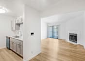 Thumbnail 26 of 42 - A kitchen with a sink, a refrigerator, and a fireplace at Water Ridge Apartments , Irving, TX