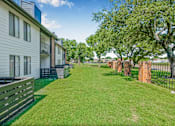 Thumbnail 34 of 42 - A grassy area in front of apartment buildings at Water Ridge Apartments , Irving, 75061