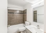 Thumbnail 30 of 42 - A white toilet sits next to a white sink in a bathroom at Water Ridge Apartments , Irving, TX, 75061