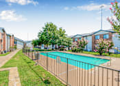 Thumbnail 38 of 42 - A pool surrounded by a fence in a sunny day at Water Ridge Apartments , Texas, 75061