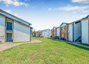 Thumbnail 37 of 42 - A row of houses with blue doors and windows at Water Ridge Apartments , Irving, TX, 75061