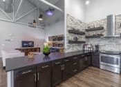 Thumbnail 1 of 65 - a kitchen with a large island and stainless steel appliances at Aviator at Brooks, San Antonio