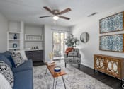 Thumbnail 5 of 35 - A living room with a blue couch and a wooden coffee table.