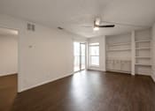 Thumbnail 29 of 35 - Empty room with wooden floor and white walls.
