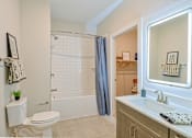 Thumbnail 20 of 52 - A white toilet sits next to a white sink in a bathroom at The Virginia Apartments , Seguin, TX, 78155