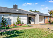 Thumbnail 6 of 42 - A small building with a grey roof and a white wall with a blue sign on it at Water Ridge Apartments , Texas