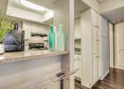 Thumbnail 4 of 37 - Fitted Kitchen With Island Dining at Newport Apartments, Irving