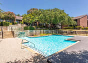 Thumbnail 24 of 35 - our apartments showcase a swimming pool  at Sunset Canyon, San Antonio, TX