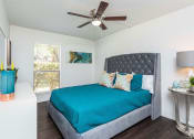 Thumbnail 8 of 35 - a bedroom with a bed and a ceiling fan  at Sunset Canyon, San Antonio, 78232
