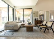 Thumbnail 15 of 35 - a living room with a white couch and a wooden coffee table in front of a sliding glass  at Sunset Canyon, San Antonio, TX, 78232