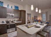 Thumbnail 1 of 22 - a kitchen with a counter top and a sink at The Grand at Stonecreek, Texas
