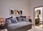 Thumbnail 4 of 22 - a living room with a couch and a door to a bathroom at The Grand at Stonecreek, San Marcos