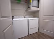 Thumbnail 5 of 22 - a washer and dryer in a closet with white doors at The Grand at Stonecreek, Texas