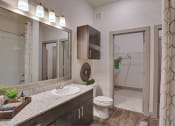 Thumbnail 6 of 22 - a bathroom with a sink and a toilet and a mirror at The Grand at Stonecreek, San Marcos, TX, 78666