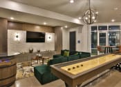 Thumbnail 8 of 22 - a living room with a pool table and a television at The Grand at Stonecreek, Texas