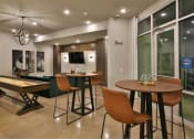 Thumbnail 11 of 22 - a game room with tables and chairs and a pool table at The Grand at Stonecreek, San Marcos, Texas