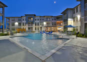 Thumbnail 18 of 22 - a swimming pool with an apartment building in the background at The Grand at Stonecreek, Texas, 78666