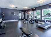 Thumbnail 45 of 55 - the gym has plenty of exercise equipment and windows at Water Ridge Apartments, Texas