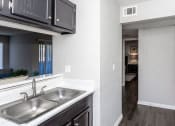 Thumbnail 42 of 55 - a kitchen with a sink and a window and a hallway at Water Ridge Apartments, Irving, TX 75061