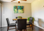 Thumbnail 4 of 55 - a dining room with a table and chairs and a painting on the wall at Water Ridge Apartments, Irving, 75061