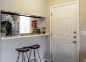 Thumbnail 3 of 55 - a bar with two stools in a kitchen with a white door at Water Ridge Apartments, Texas