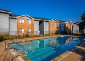 Thumbnail 29 of 55 - a swimming pool in front of apartments with a pool at Water Ridge Apartments, Texas