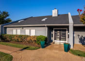 Thumbnail 46 of 55 - the front of a house with a driveway and a glass door at Water Ridge Apartments, Irving, Texas